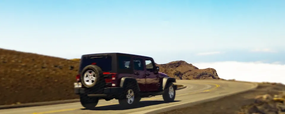 Four door Jeep Wrangler rental driving up Haleakala